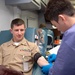 Lt. Mathew Mariano looks on as his blood donation begins during the Armed Services Blood Program (ASBP) blood drive at Commander, U.S. Second Fleet headquarters, Feb. 7