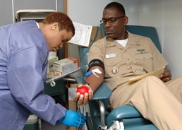 Senior Chief Culinary Specialist Edward Sivells gives blood during the Armed Services Blood Program (ASBP) blood drive at Commander, U.S. Second Fleet headquarters, Feb. 7.