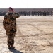A German officer salutes during the German National Anthem at a TF Kunduz change of command