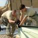 Members of U.S. Air Force 877th Expeditionary Prime Beef Squadron prepare to erect an Alaskan Small Shelter System in Camp Ghowrmach