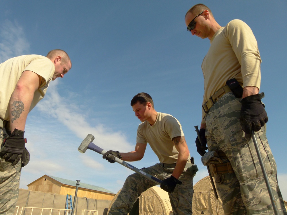 Members of U.S. Air Force 877th Expeditionary Prime Beef Squadron prepare to erect an Alaskan Small Shelter System at FOB Ghowrmach