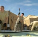 Members of U.S. Air Force 877th Expeditionary Prime Beef Squadron prepare to erect an Alaskan Small Shelter System at FOB Ghowrmach