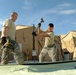 Members of U.S. Air Force 877th Expeditionary Prime Beef Squadron prepare to erect an Alaskan Small Shelter System at FOB Ghowrmach