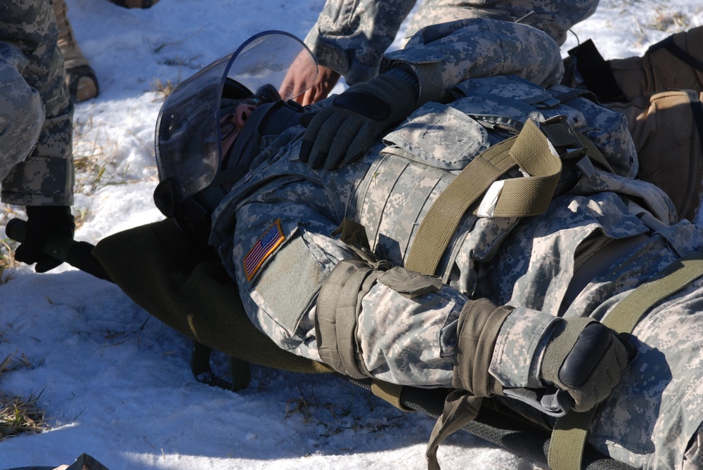 Soldier acts as simulated casualty during riot exercise