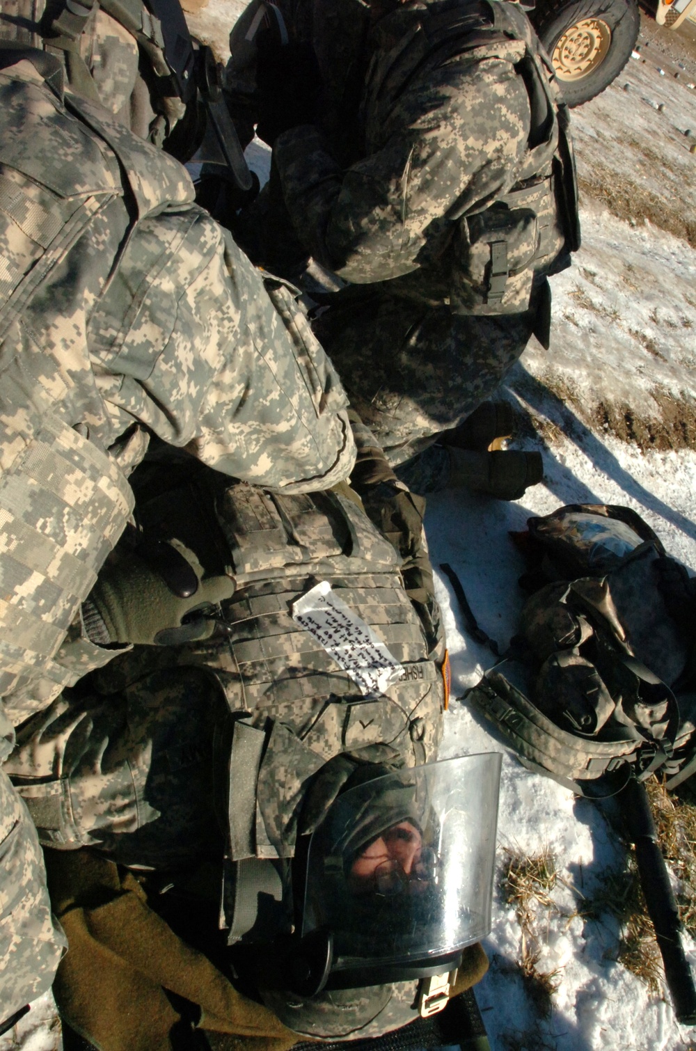 Soldier acts as simulated casualty during riot control exercise