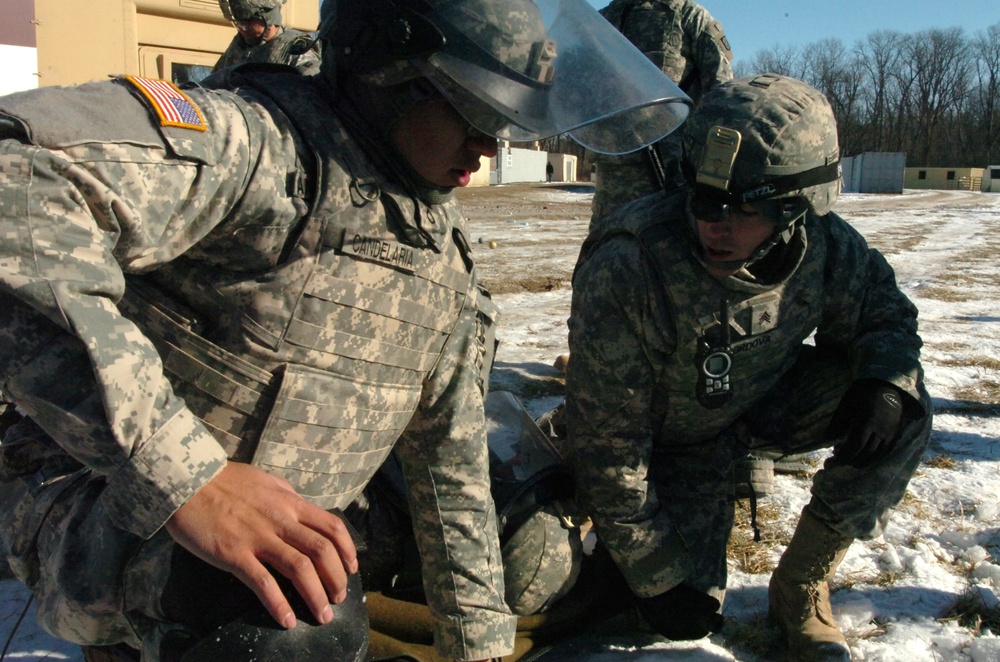 New Mexico National Guard medics lift simulated casualty during riot control exercise