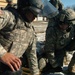 New Mexico National Guard medics lift simulated casualty during riot control exercise