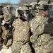 New Mexico National Guard infantry soldiers brace themselves against mock rioters during exercise