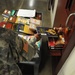 A soldier from the detainee library hands a book to a detainee in Camp Five