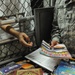 A soldier from the detainee library hands a periodical to a detainee in Camp Five