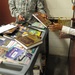 A soldier from the detainee library hands a book to a detainee in Camp Five,