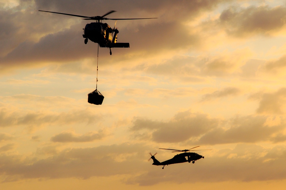 MH-60S Sea Hawks Transfer Ammunition Above the Atlantic