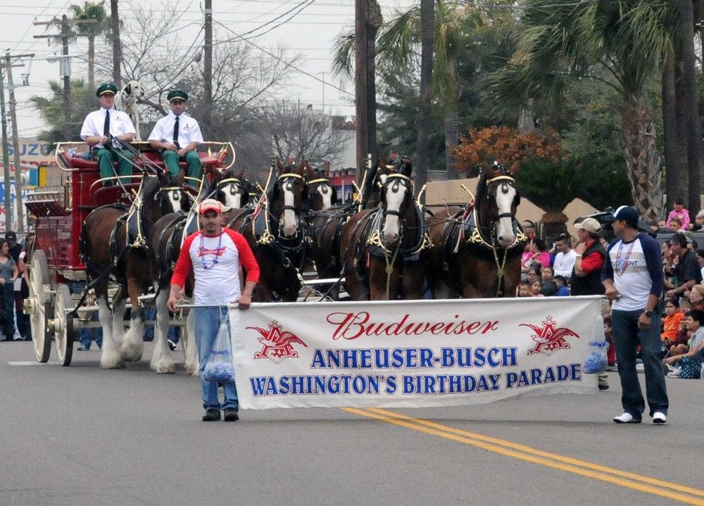 Participants march in the Anheuser-Busch Washington's Birthday Parade in Laredo