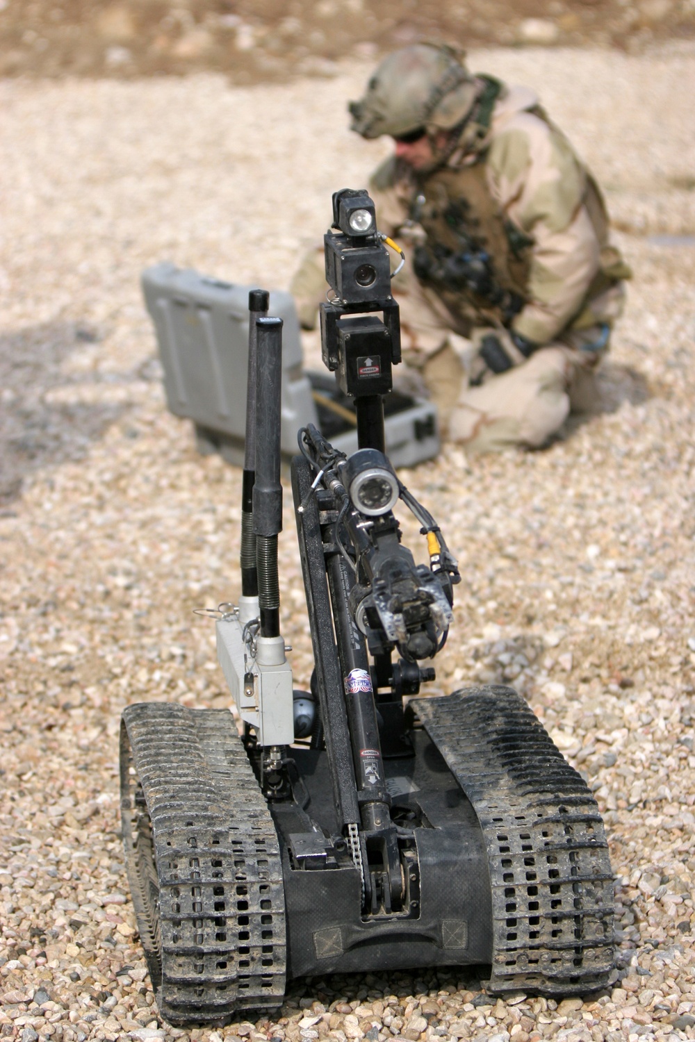 A US Navy EOD technician demonstrates the capabilities of their remote-controlled robot, used for inspecting IEDs