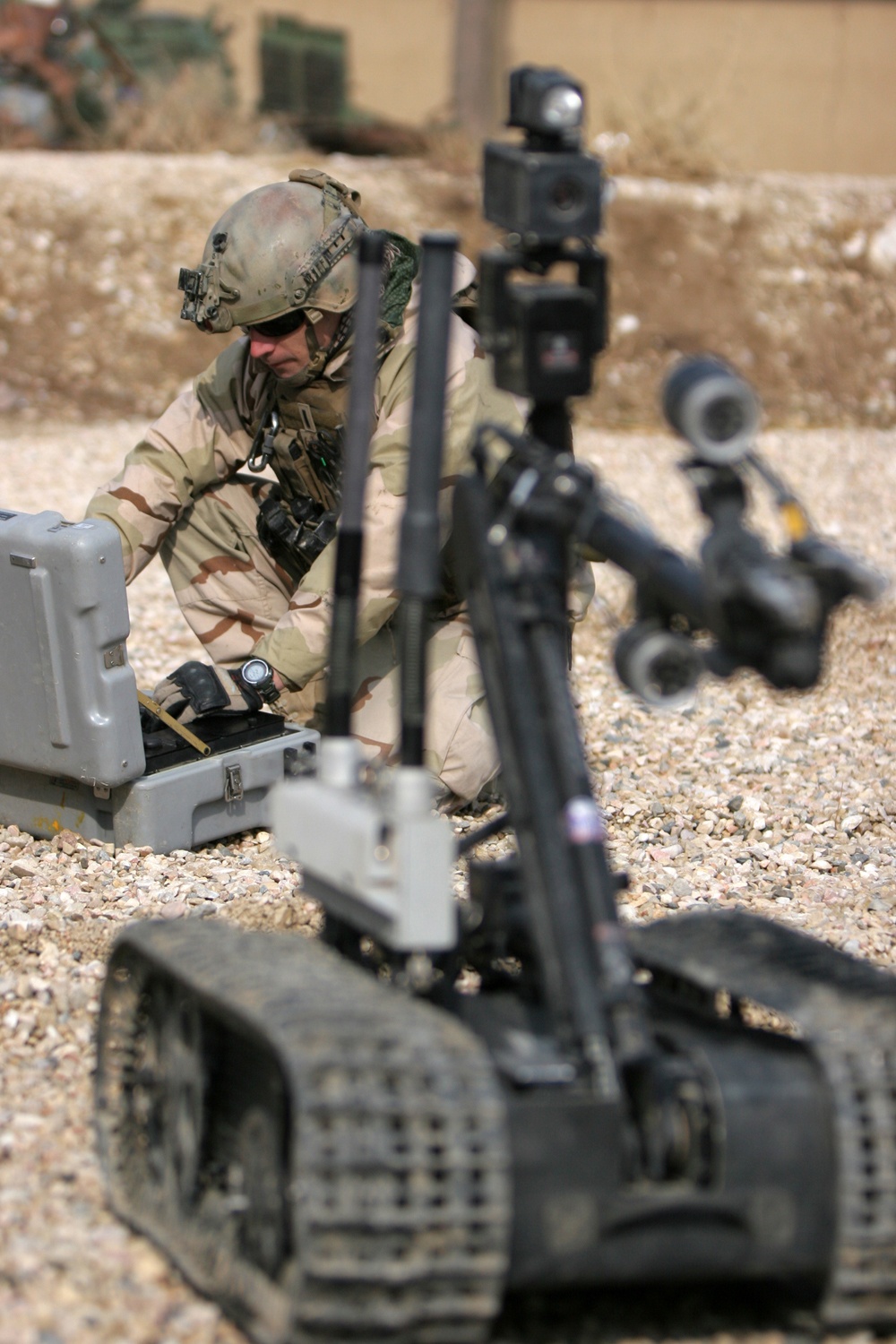 A US Navy EOD technician demonstrates the capabilities of their remote-controlled robot, used for inspecting IEDs