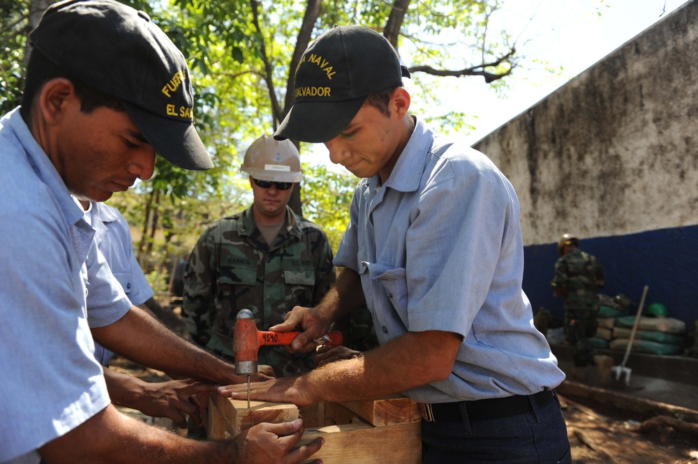 NMCB 28 Sailors Help Build a Classroom Bench