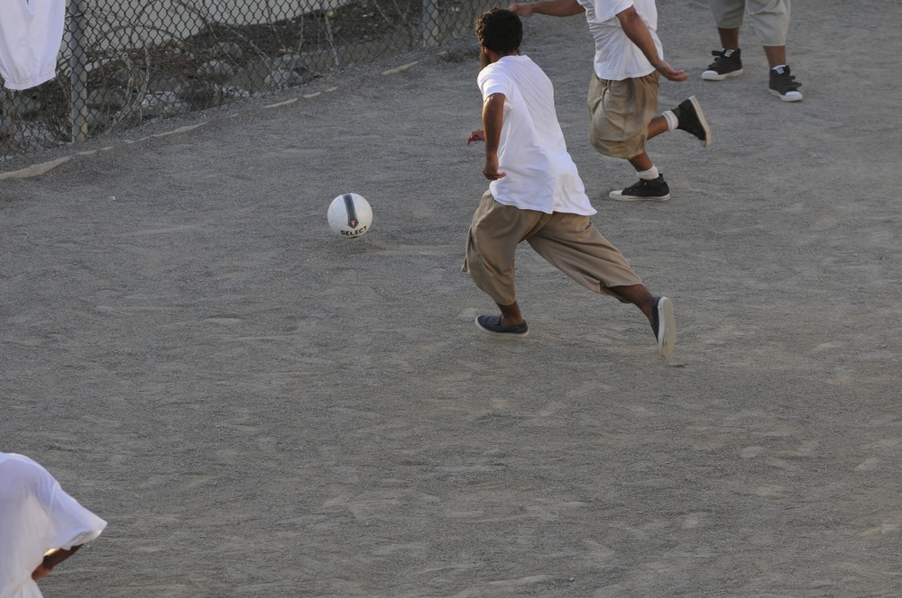 Detainees play soccer in the recreation area of Camp Six