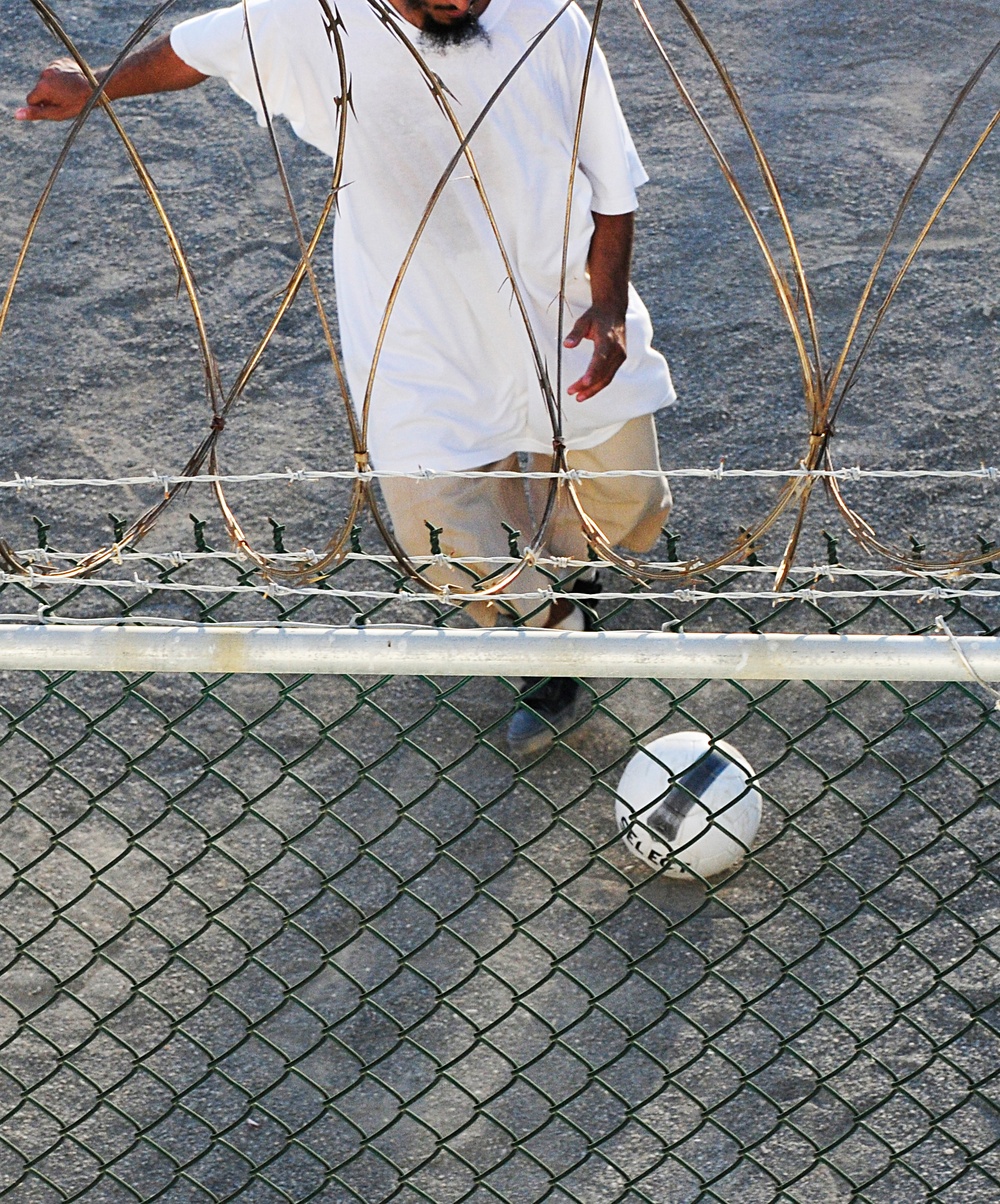 A detainee plays soccer in the recreation area of Camp Six at Joint Task Force Guantanamo