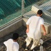 Detainees play soccer within the outdoor recreation area of Camp Six at Joint Task Force Guantanamo