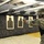 432nd CA BN prepares for deployment to Afghanistan A soldier in U.S. Army ACU (Army Combat Uniform) digital camouflage is firing a pistol at an indoor shooting range. The shooter is wearing a black tactical vest, ballistic eye protection, hearing protection, and a patrol cap. Multiple silhouette paper targets are mounted on a target rail system downrange.