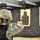 432nd CA BN prepares for deployment to Afghanistan A female soldier in U.S. Army ACU (Army Combat Uniform) is firing a pistol at an indoor shooting range. She is wearing a combat helmet, hearing protection, and a body armor vest marked 'NWTC-Lg'. Multiple silhouette paper targets are visible downrange.