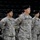 432nd CA BN prepares for deployment to Afghanistan A group of U.S. Army soldiers in ACU (Army Combat Uniform) camouflage pattern are standing in formation, likely during a ceremony or official event held in an indoor arena. The soldiers are wearing black berets and have name tapes, U.S. Army tapes, and American flag patches visible on their uniforms. The foreground soldier, identified by name tape as 'SCHAUER,' appears to be at attention or parade rest.