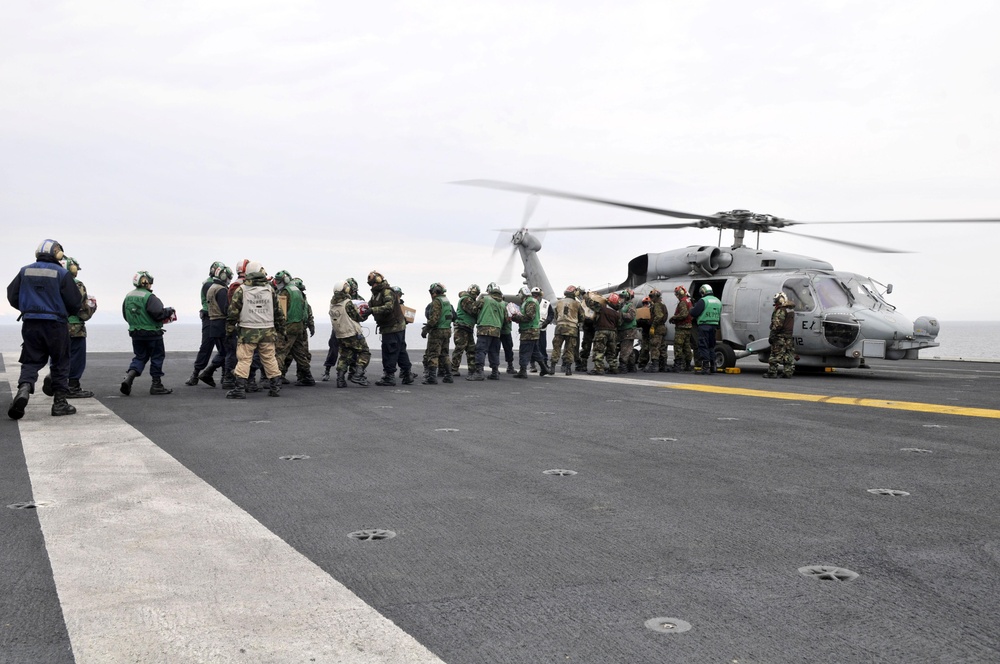 Sailors and Marines Load Supplies Aboard the USS Ronald Reagan