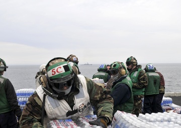 Sailors and Marines Load Supplies Aboard the USS Ronald Reagan