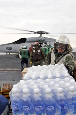 Sailors and Marines Load Supplies Aboard the USS Ronald Reagan