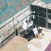 Two detainees wash a mat in the outdoor recreation area of Camp Six at Joint Task Force Guantanamo