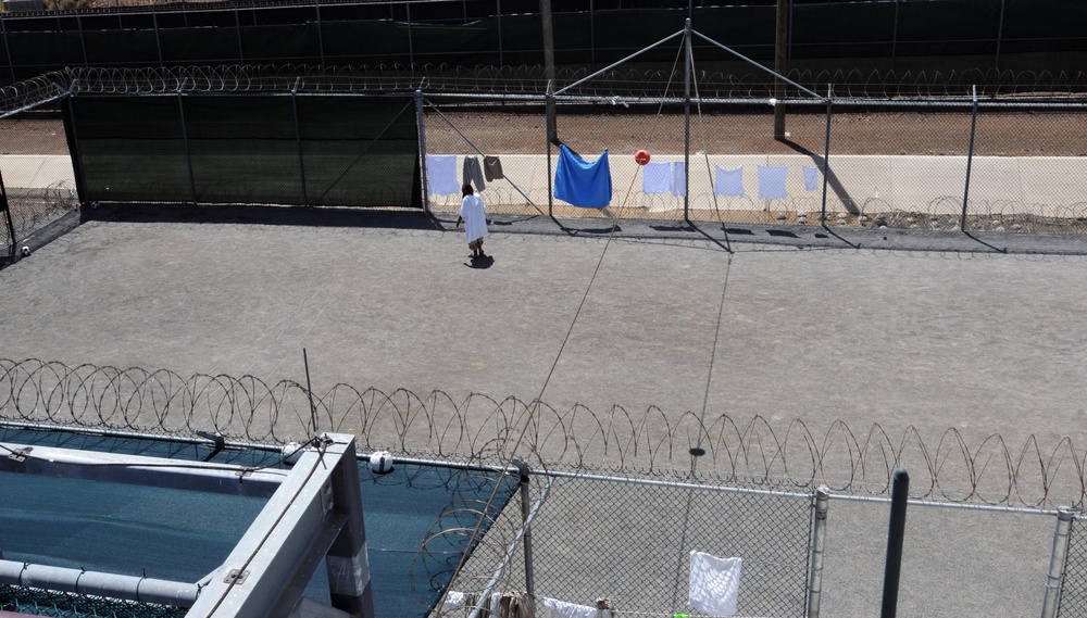 A detainee walks in the outdoor recreation area of Camp Six at Joint Task Force Guantanamo