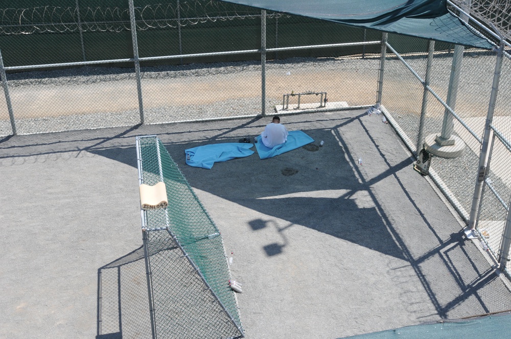 A detainee relaxes in the outdoor recreation area of Camp Six at Joint Task Force Guantanamo