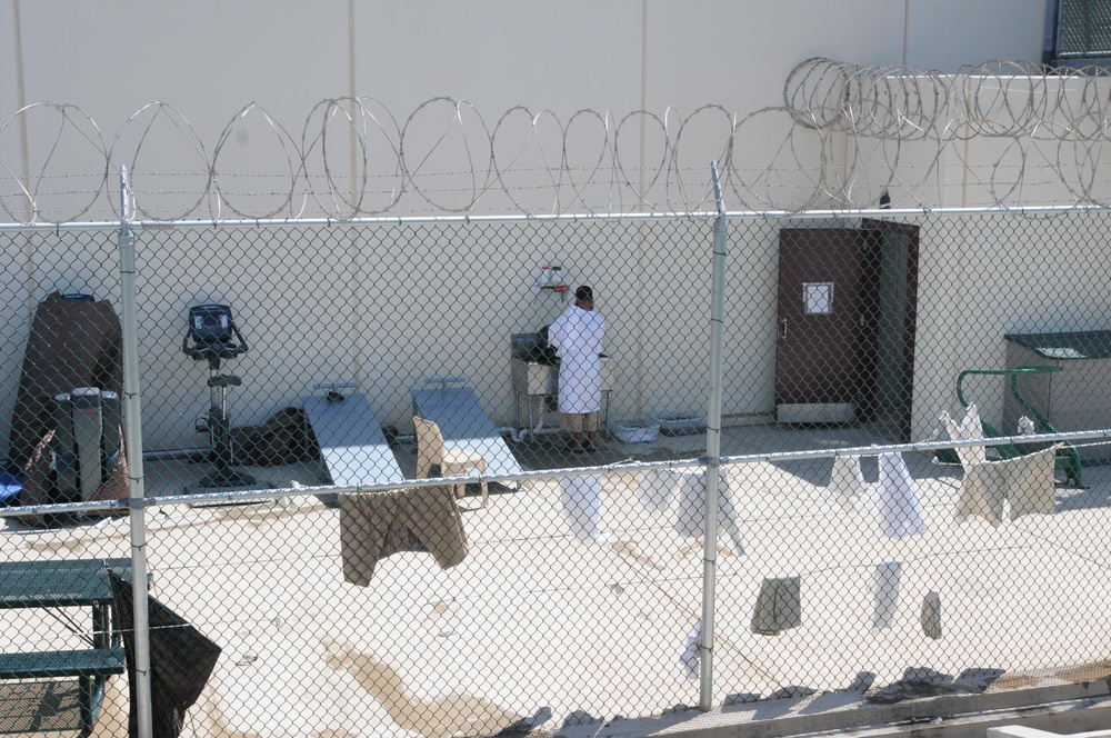 A detainee uses a sink in the outdoor recreation area of Camp Six at Joint Task Force Guantanamo