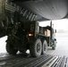 Troops give the thumbs-up as a truck is loaded onto a C-17 aircraft