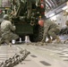 Airmen secure trucks in a C-17 aircraft