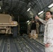 Seabee Chief gives a thumbs-up as a truck is loaded onto a C-17 aircraft