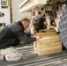 Seabees secure a truck onboard a C-17 aircraft for transport
