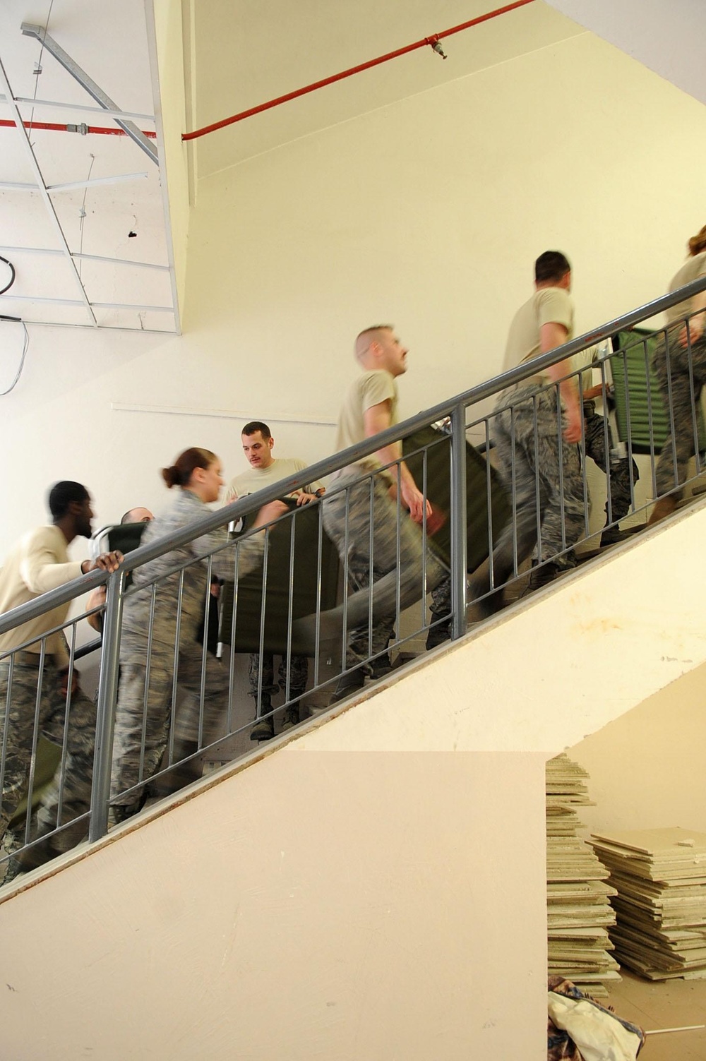 Airmen Moving Cots for Incoming Personnel at Aviano AB