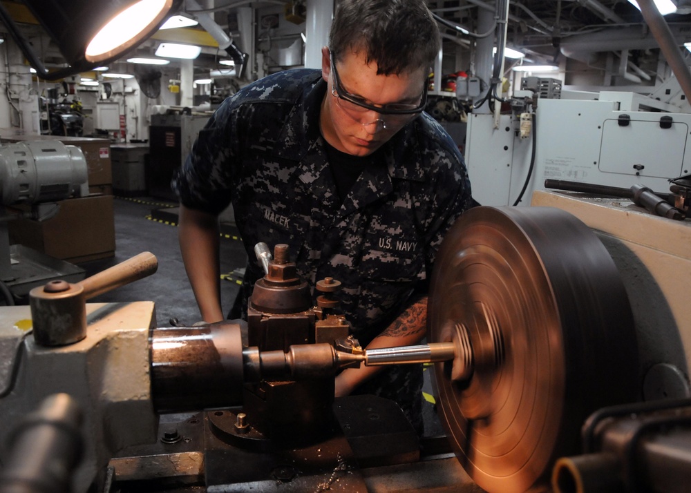 USS Frank Cable Sailor Repairs Paper Pin