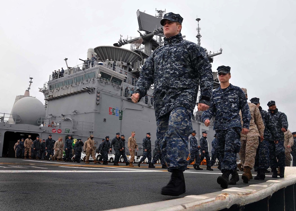 Sailors and Marines Prepare to Man the Rails Aboard the USS Bataan