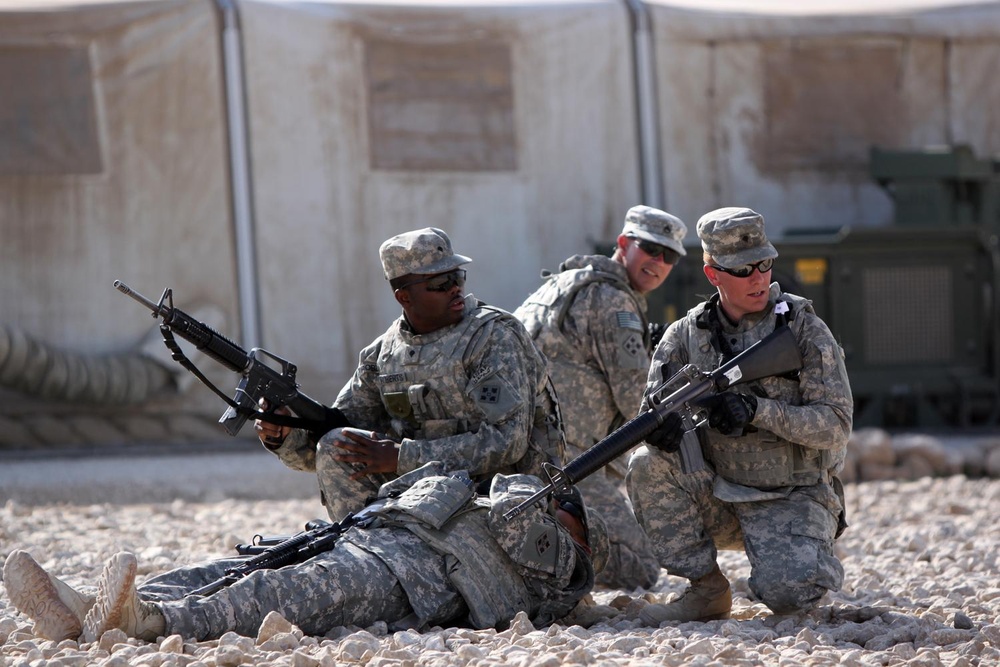 Soldiers provide security in a simulated training exercise