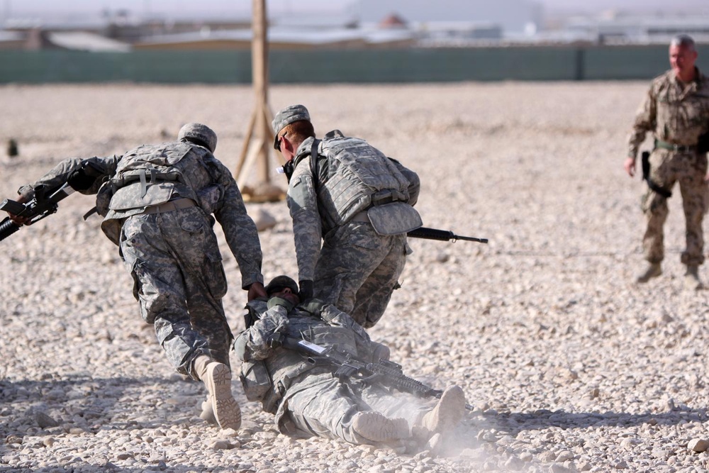 During a training exercise, troops drag their comrade to safety