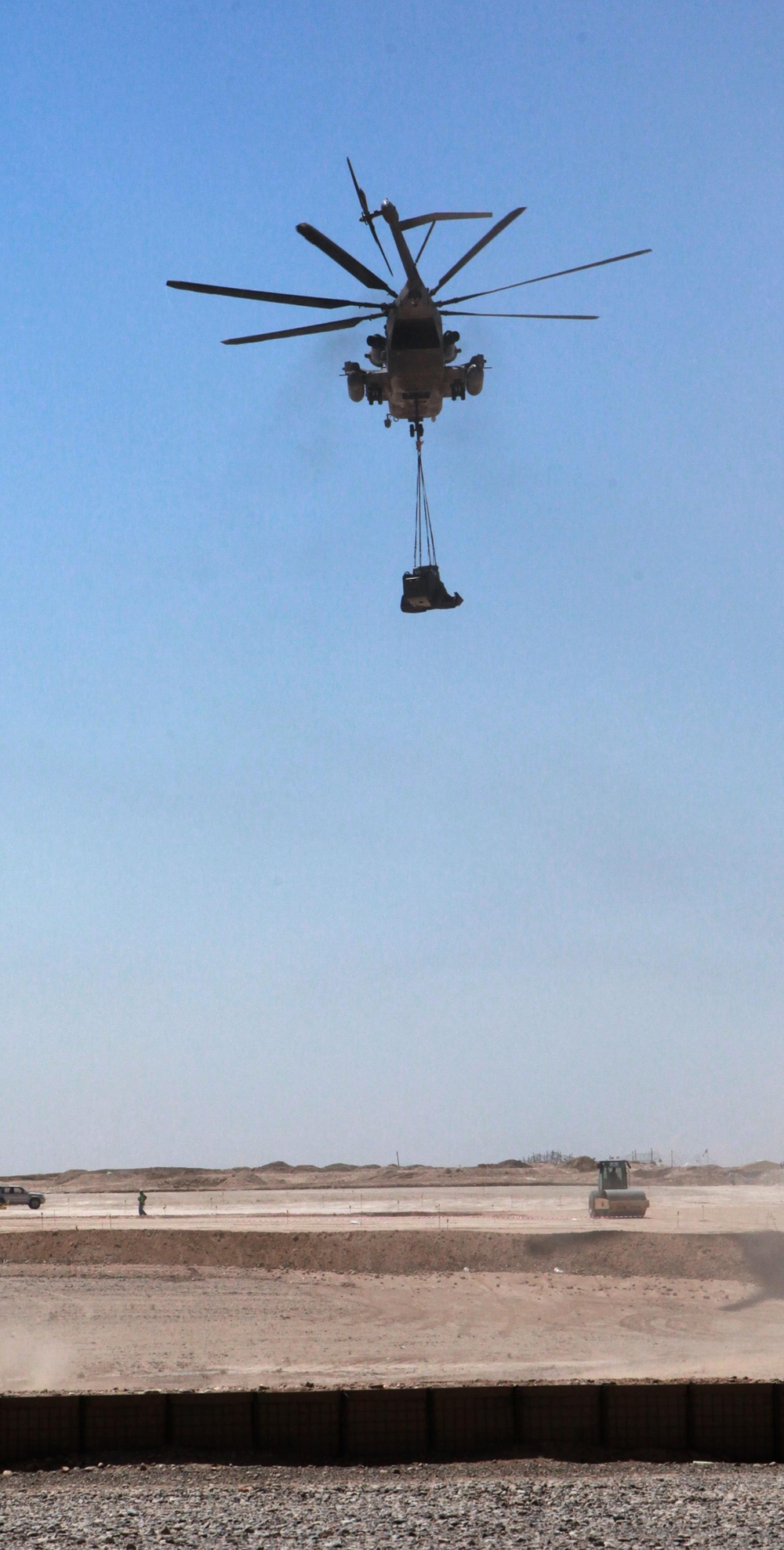 Helicopter support team sends heavy equipment via air