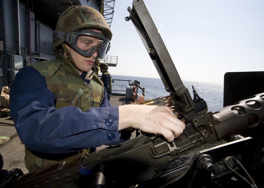 Sailors fire machine gun