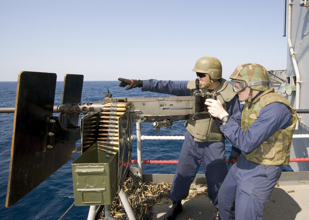 Sailors fire machine gun