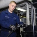 USS Kearsarge Sailor Works on Burner Barrel