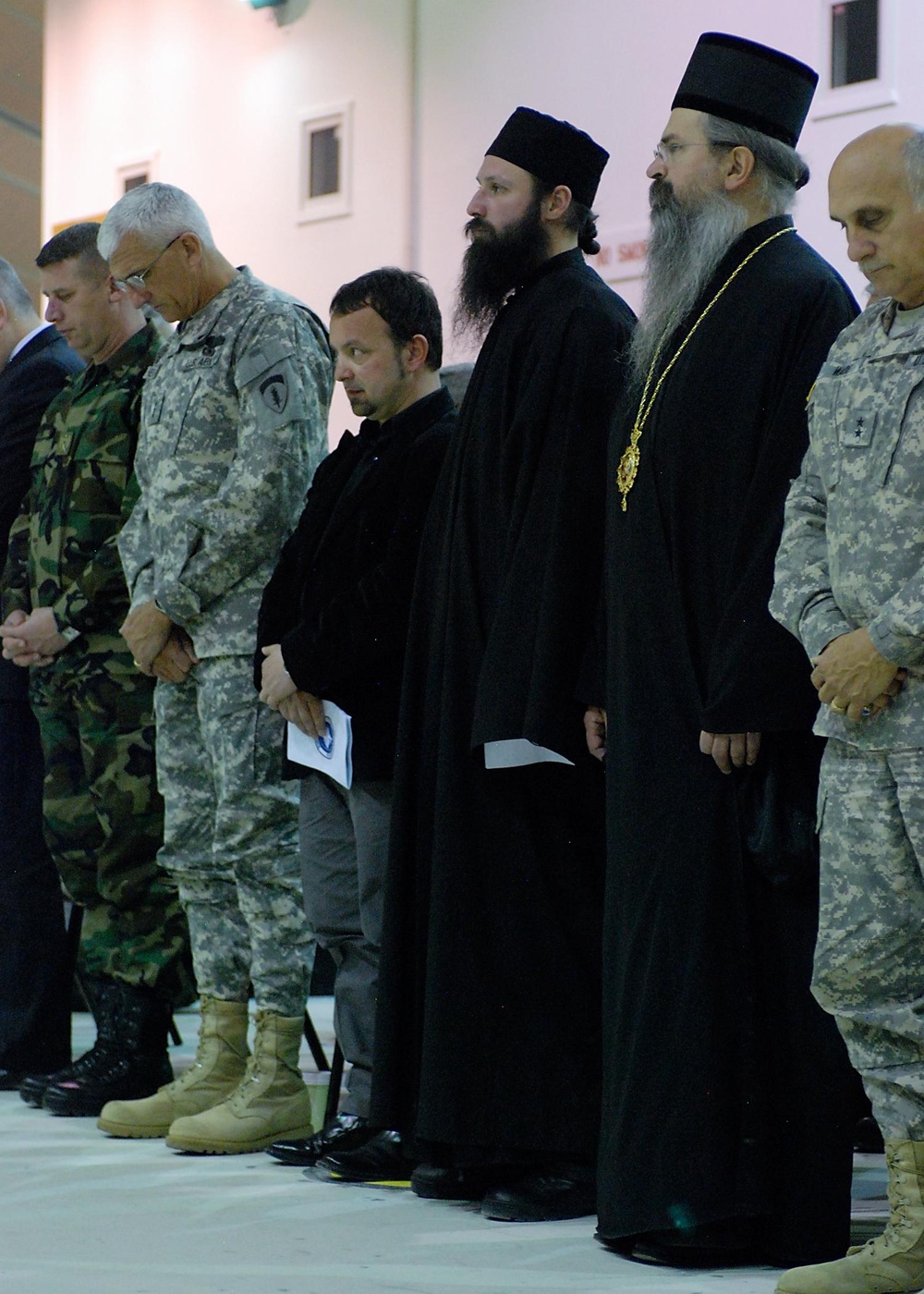 Visiting dignitaries take part in moment of silence during benediction at transfer of authority ceremony