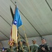 Multinational soldiers present arms during transfer of authority ceremony