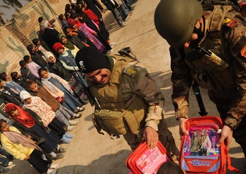 Iraqi special operations forces hand out backpacks