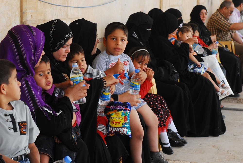 Vanguard Brigade Soldiers help distribute wheelchairs to disabled Iraqi children